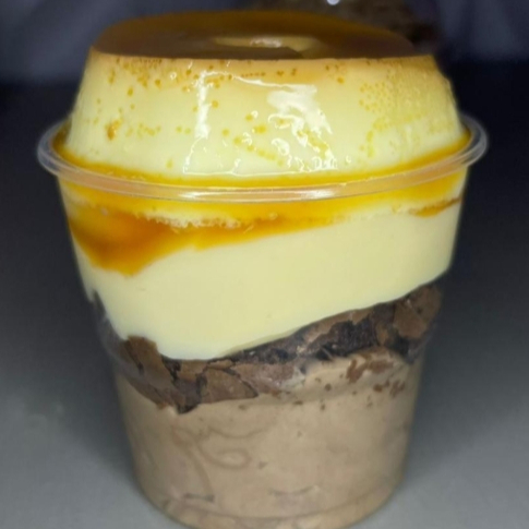 Uma combinação perfeita para quem ama sobremesas irresistíveis! Nosso copo traz camadas de pudim cremoso e delicado, intercaladas com pedaços macios de brownie de chocolate. O contraste entre a suavidade do pudim e a intensidade do brownie cria uma explosão de sabor a cada colherada. Prático, delicioso e na medida certa para matar a vontade de doce. Ideal para saborear sozinho ou compartilhar um momento especial!