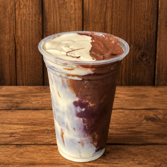 Açaí super cremoso montado em camadas de leite em pó, creme de avelã e creme ninho