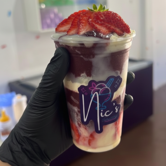 Açaí cremoso no copo, dividido em deliciosas camadas de leite condensado, leite em pó e morangos fresquinhos. Muito sabor pra um copo só!