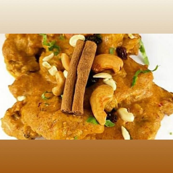 Filet de coxa e sobrecoxa ao molho de iogurte, castanha de caju, passas, amêndoas, coentro e especiarias. Indicação da compra de um pão para acompanhamento.