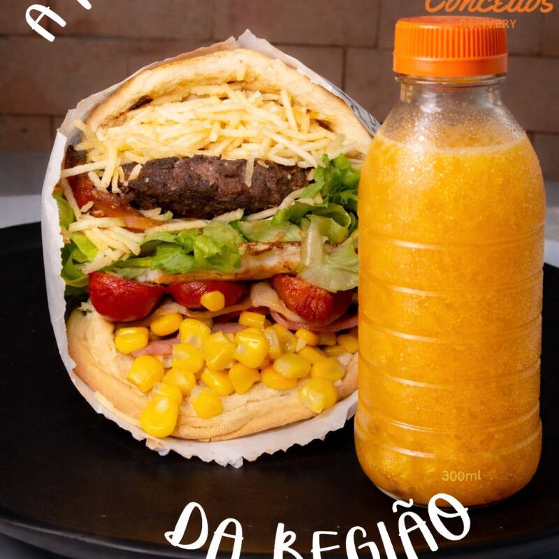 Escolha sua carne, Ovo, Salsicha, Bacon, Presunto, Mussarela, Alface, Tomate, Batata palha e Milho. Acompanha Suco 300 ML