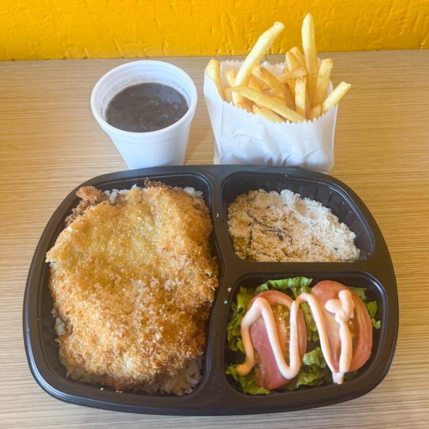 Arroz soltinho, feijão temperado, bife de alcatra à milanesa feito na hora, batata frita sequinha, farofinha e salada fresca. Comida bem feita, com gosto de casa.