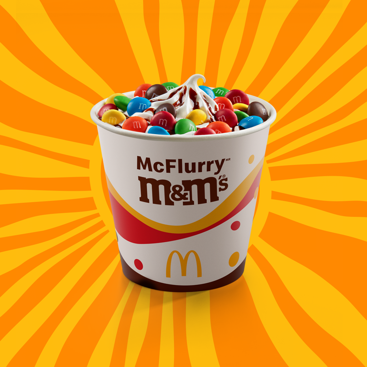 Sobremesa composta por bebida láctea sabor baunilha, cobertura sabor chocolate, caramelo ou morango e confeitos de chocolate M&M’s ao leite.