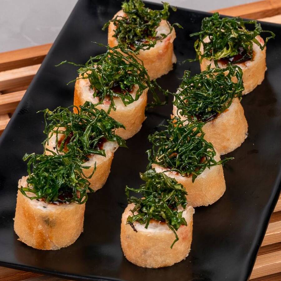 Roll com massa de harumaki, salmão, kani, cebolinha, cream cheese, gergelim, palha de couve e teriyaki (8 und).