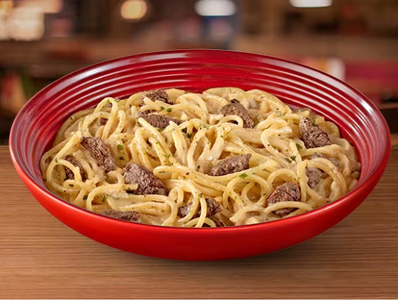 Spaghetti preparado com molho Alfredo, acompanhado de tiras de filet mignon suculento, e um delicioso mix de queijo parmesão Faixa Azul e blue cheese.