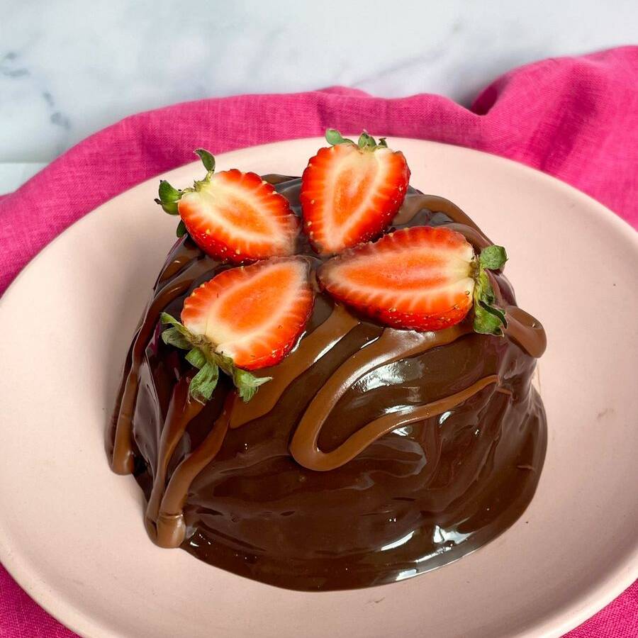 Serve de 2 a 4 pedaços e pesa aproximadamente 350g. Massa de chocolate 50% cacau, extremamente úmida e saborosa. Recheado por uma cobertura cremosa e quentinha de chocolate e finalizado com Nutella e morangos.