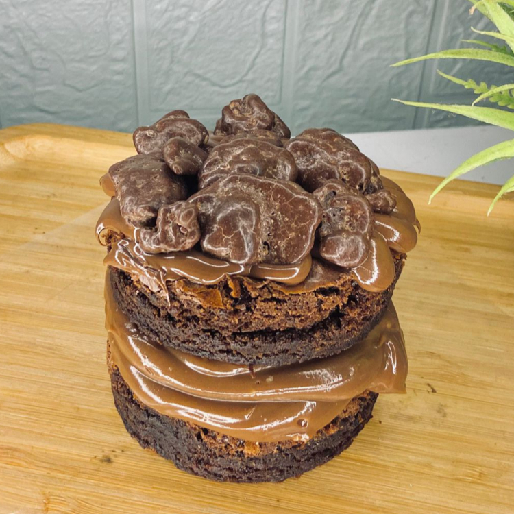 Duas camadas de brownie molhadinho, recheio de brigadeiro de chocolate 50% cremoso ao meio. Finalizado com nutella e ovomaltine rocks em pedaços. Esse doce é ideal para uma pessoa, mas se comer pouco, dá para dividir.