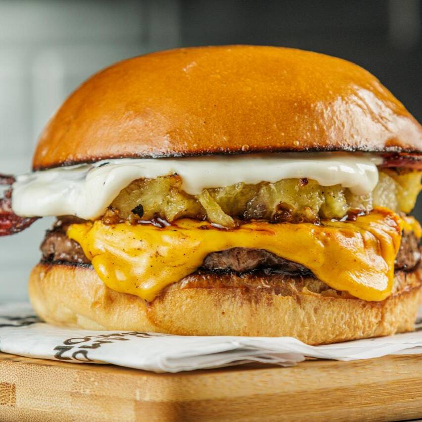 Pão brioche, Blend Angus 160g na brasa, cheddar, bacon, abacaxi caramelizado, maionese da casa e molho agridoce.