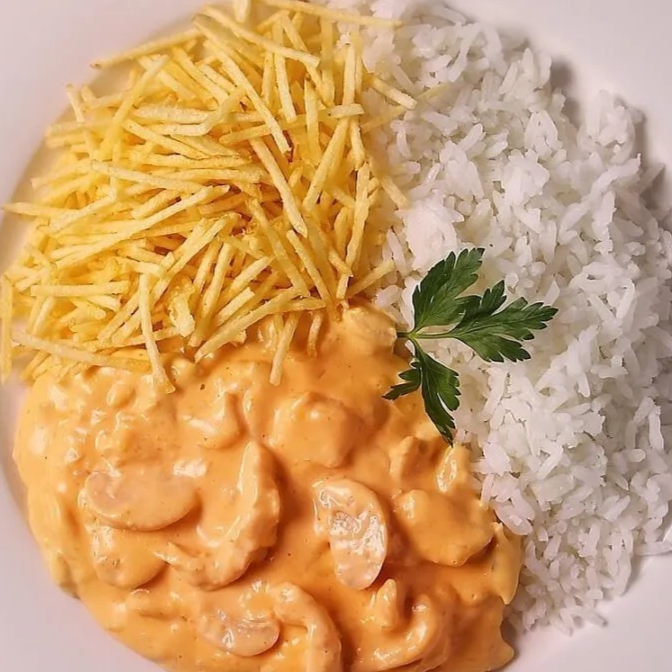Strogonoff de frango cremoso, bem temperado e cheio de sabor, acompanhado de arroz soltinho e batata palha crocante. Uma combinação clássica e irresistível, perfeita para quem quer uma refeição saborosa e com gostinho de comida caseira.