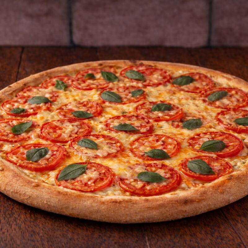 Uma combinação elegante de mussarela fresca, tomates maduros e manjericão aromático, criando uma experiência de sabor refrescante e autêntica.