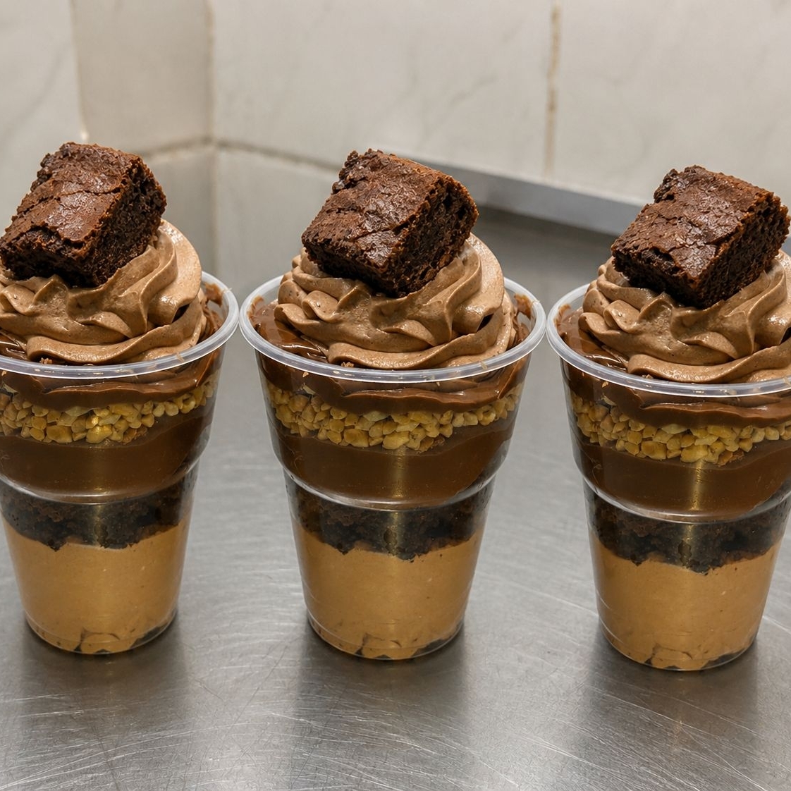 Mousse de chocolate, pedaços de brownie, brigadeiro ao leite, amendoim e Nutella .