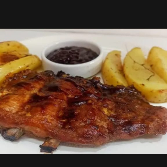 COSTELA NO BAFO SUINA ASSADA NA BRASA, COM ARROZ A LA GREGA, BATATA RUSTICA, FAROFA DE OVOS E MOLHO A CAMPANHA