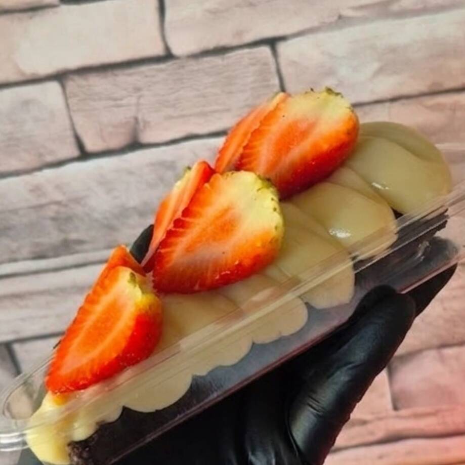 Brownie feito com chocolate nobre meio amargo, com cobertura cremosa de brigadeiro de leite ninho e pedaços de morangos selecionados ...Cada mordida é uma explosão de sabor e textura