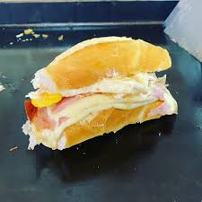 Pão francês com queijo, presunto e um ovo frito