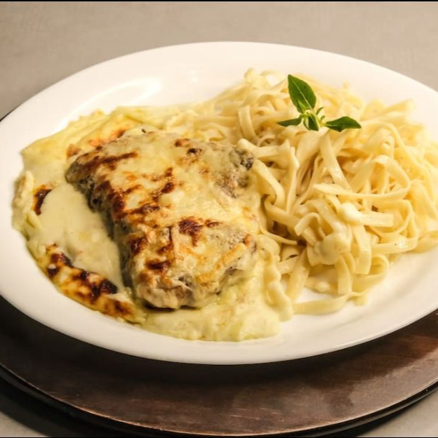 Peito de frango empanado e gratinado ao molho quatro queijos, acompanha nhoque caseiro ou talharim.