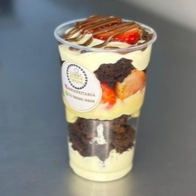 O nosso shaKe de brownie Ninho é um verdadeiro patrimônio da Mosfeitaria! Feito com brownie de Ninho, mousse de Ninho, morangos frescos e brigadeiro de Ninho, tudo finalizado com Nutella. Uma explosão de sabores que conquistou a todos e é impossível resistir! - APROX. 250GR