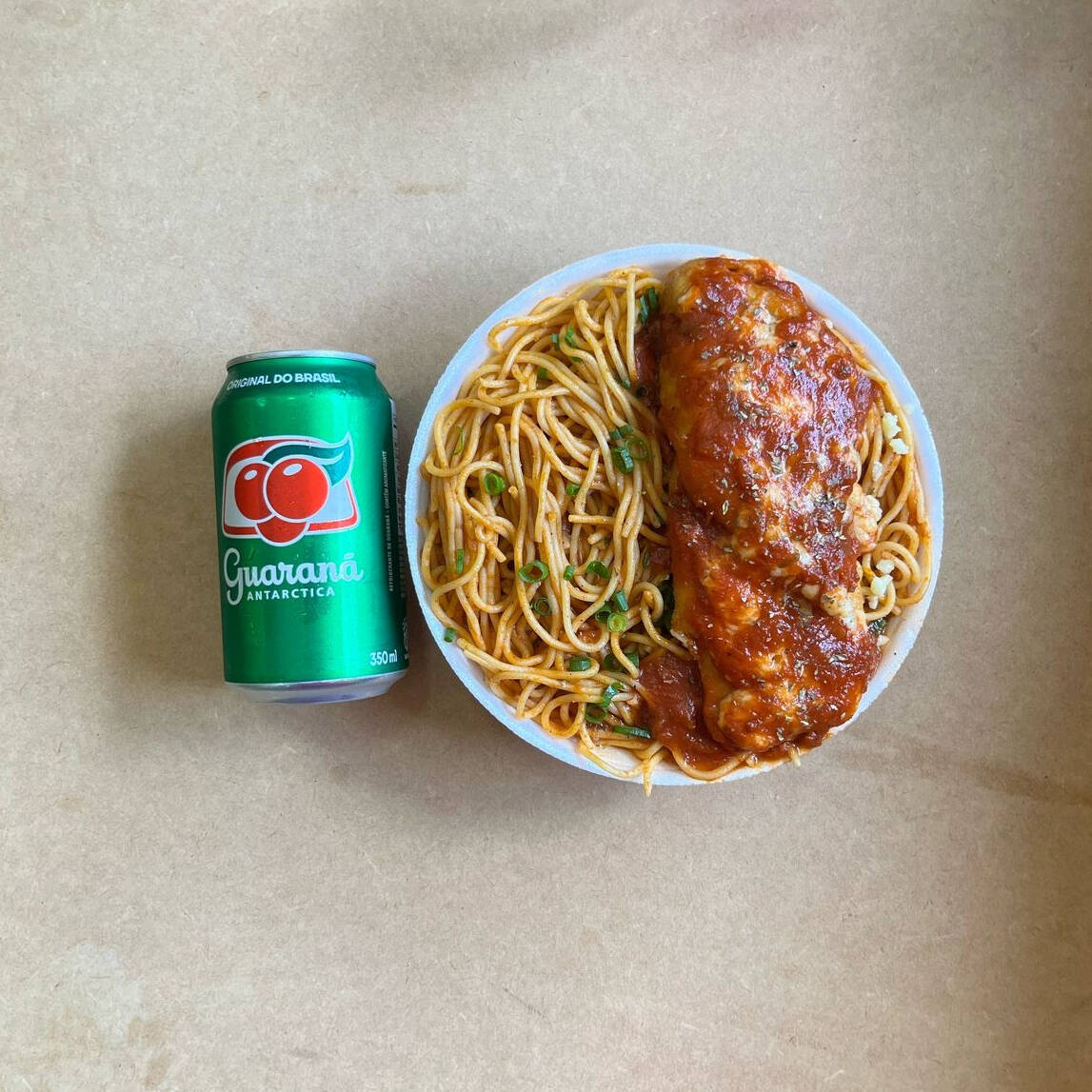 Marmita com delicioso filé de frango parmegiana (empanado na massa crocante coberto com molho de tomates e queijo) acompanhado de macarrão espaguete ao molho de tomates. Acompanha refrigerante lata Guaraná Antárctica lata 350ml bem gelada. Marmita indicada para 01 pessoa.