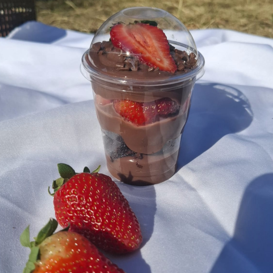 Copo feito com brigadeiro cremoso de chocolate, brownie bem molhadinho com casquinha crocante e morangos selecionados