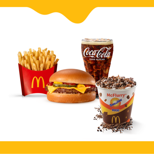 Um hamburguer (100% carne bovina), queijo cheddar, cebola, picles, ketchup, mostarda e pão sem gergelim, acompanhamento, bebida e McFlurry Ovomaltine Rocks