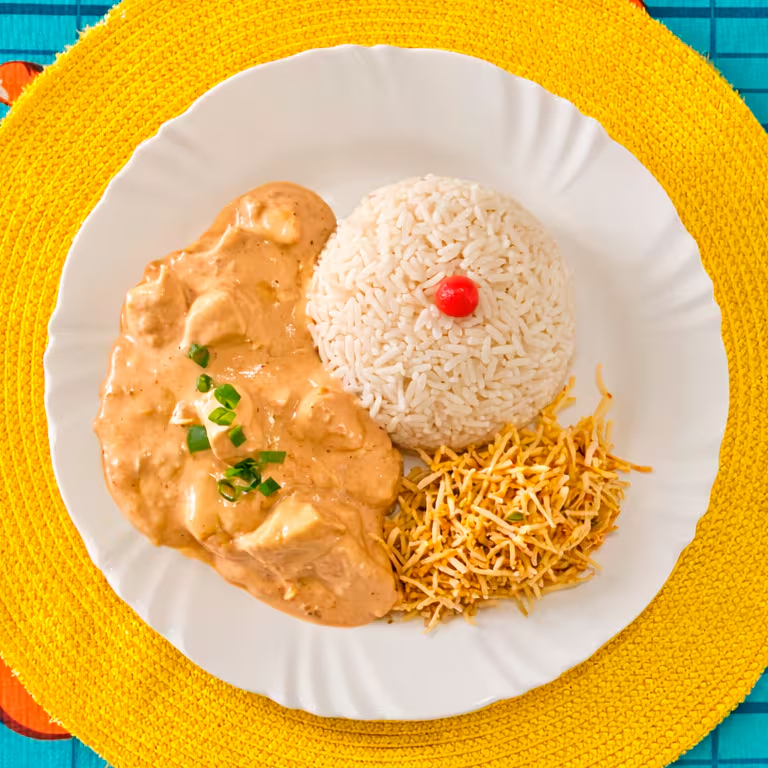 Peito de frango em cubos envolvido em molho cremoso especial. Acompanha arroz branco soltinho e batata palha extra crocante. Serve 1 pessoa.