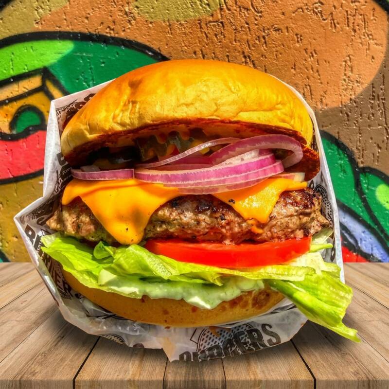 pão brioche macio da maná selado na manteiga com hamburguer de 100g , alface fresquinho americana , bacon crocante , queijo cheddar derretido e molho especial da casa tomate cebola e entrega gratis