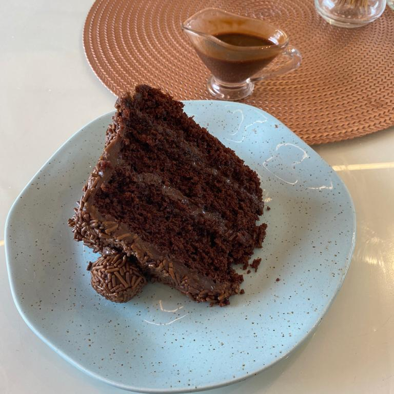 Bolo de brigadeiro, com duas camadas de chocolate e docinho de brigadeiro.