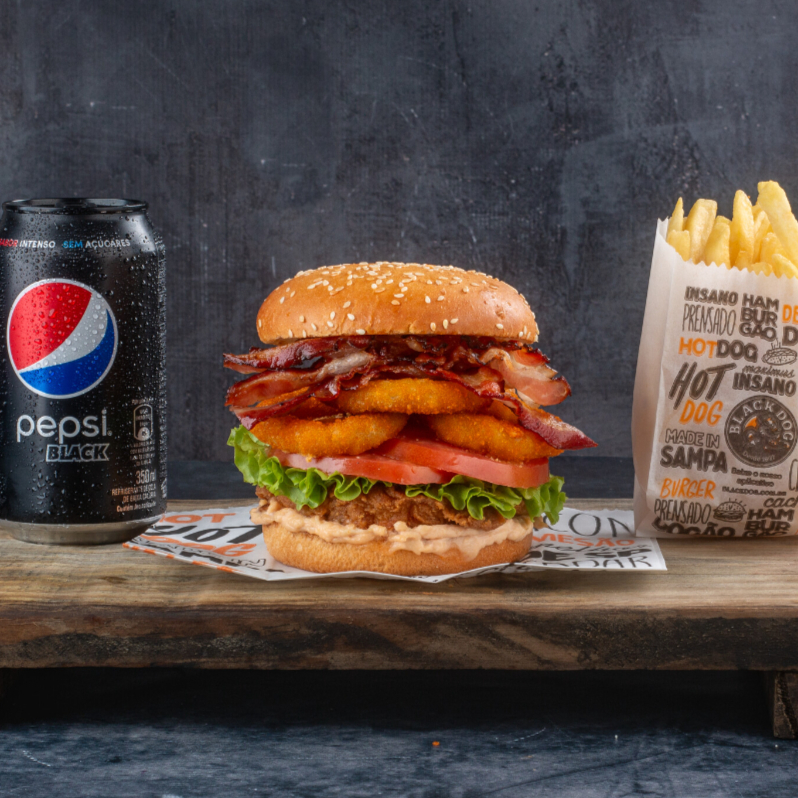 Acompanha Fritas + Refri Chicken All In: 2 tiras de frango empanado, pão brioche, com ou sem gergelim, queijo, onion rings, bacon, alface, tomate e maionese Black Dog.