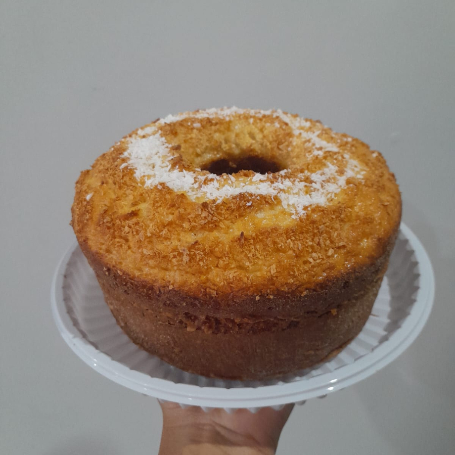 Bolo com a massa feita com coco, com um pouco de coco ralado por cima . (aprox. 600g, serve 4 pessoas )