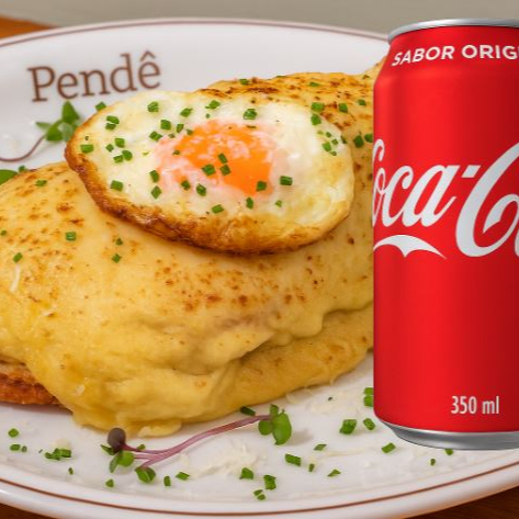 Refri Lata + Fatia de pão Sourdough/ Carne desfiada/ Queijo emmental/ Bechamel de bacon/ Ovo frito (gema mole) Obs: O ovo frito poderá ter gema estourada ou passar do ponto (devido ao calor na embalagem), durante o transporte.