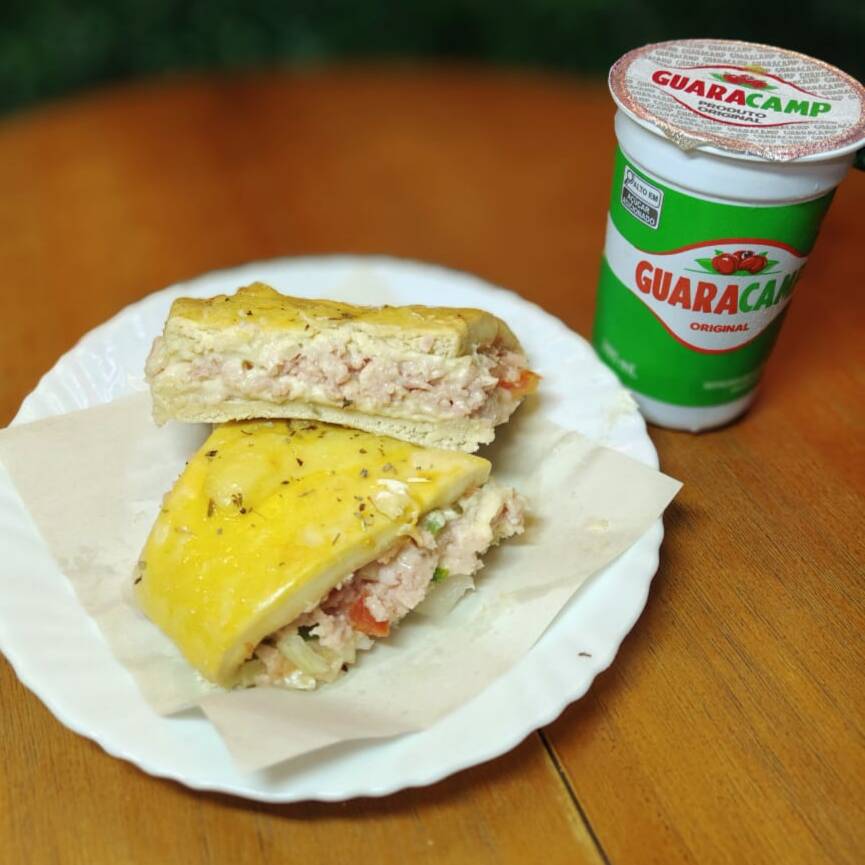 Pastelão de queijo e presunto, assado até ficar douradinho e com recheio cremoso, acompanhado de refrescante guaraná natural. Um combo delicioso e perfeito para qualquer hora.