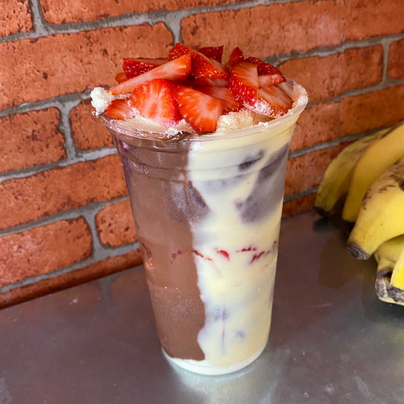 Açaí artesanal trufado com recheio de avelã e cacau, recheio de leitinho, leite em pó, ovomaltine e morangos frescos