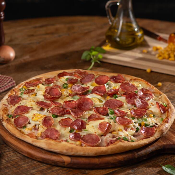 Molho de tomate italiano, presunto, ovos, milho, ervilhas, cebola, muçarela, calabresa, orégano e azeitonas verdes sem caroço.