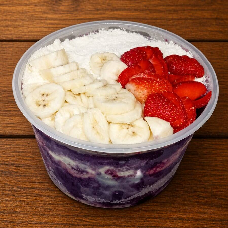 Açaí super cremoso, montado em camadas de leite em pó + leite condensado ,no topo banana e morango.