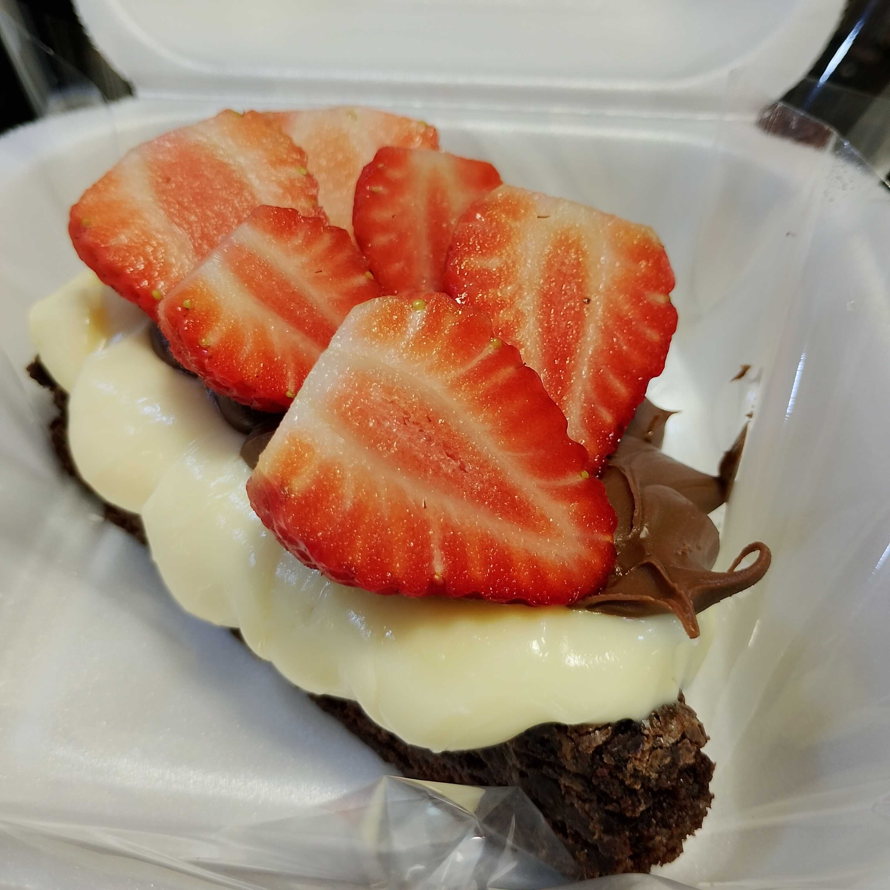 O seu brownie favorito em formato de pizza para você comer com as mãos ou de colher! Uma fatia triangular generosa do nosso brownie super denso e fudgy, coberta com o cremoso brigadeiro de Leite Ninho e com o irresistível creme de avelã. Para coroar essa perfeição, morangos frescos e suculentos por cima de tudo.