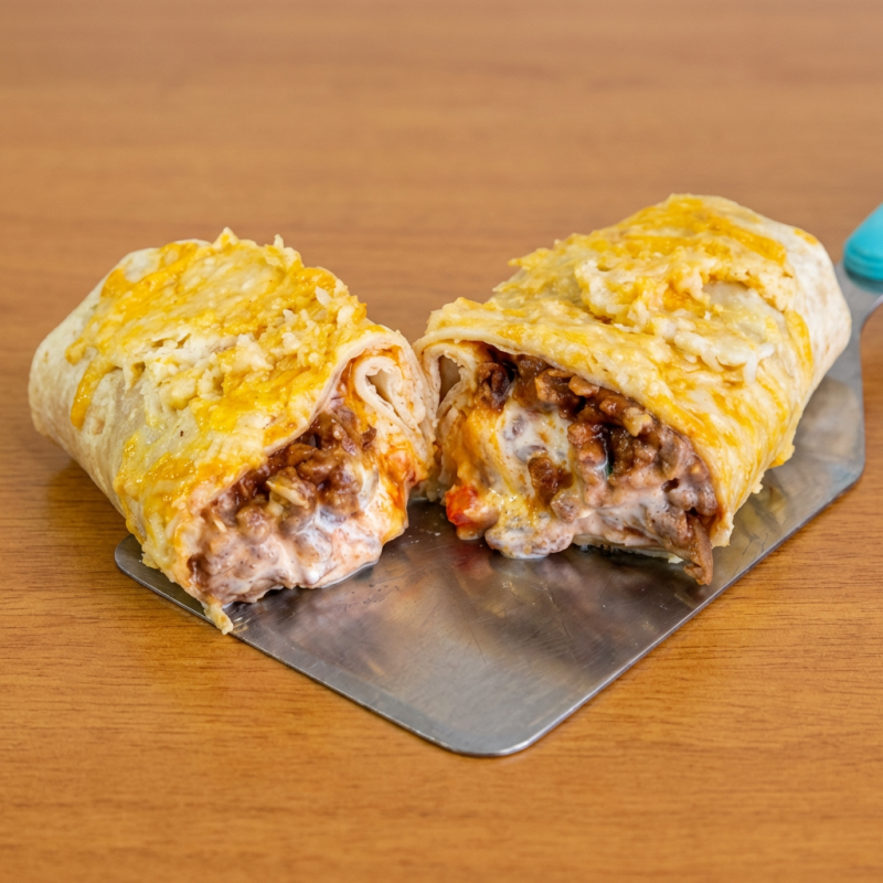 "Tortilla de trigo recheada com carne vegetal, mozzarella vegana, sour cream, cheddar cremoso e uma camada de muito queijo vegetal grelhado por cima. Sem pimenta. Para adicionar pimentas, selecione no campo complementos. Para pedir molhos ou pimentas a parte, selecione também o item ""embalagem extra"""Atenção: NÃO TEM COMO RETIRAR COENTRO, CEBOLA E ALHO Peso médio:190g