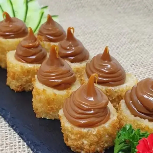 Um enrolado de nori por fora , por dentro Arroz Japones com banana canela empanado na Farinha Banco e frito