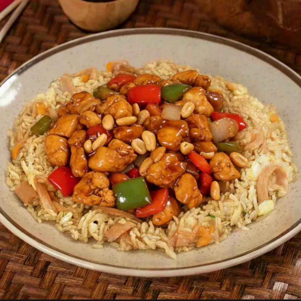 Arroz frito com pedaços de frango, pimentões, amendoim e molho yakisoba, trazendo o clássico sabor do frango xadrez em cada garfada