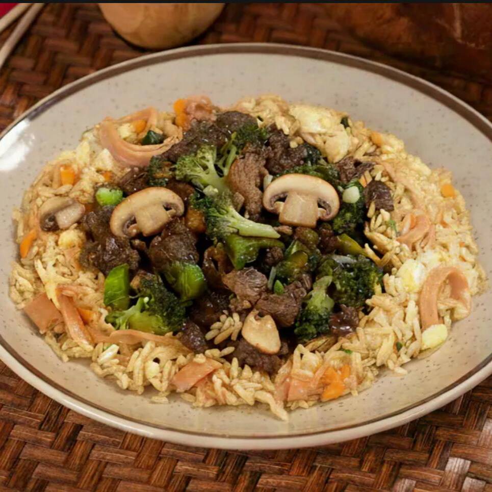 Arroz estilo yakimeshi combinado com carne suculenta, brócolis crocantes e cogumelos champignon fatiados, tudo envolto em molho yakisoba. Uma refeição nutritiva e deliciosa.