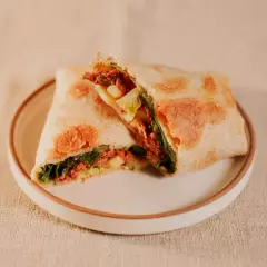 Tortilla integral, maionese, mix de folhas verdes, ragu de carne, tomate grape, maçã verde e molho missô ginger.