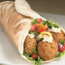 Pão Sírio, 4 Bolinhos de Falafel(Grão de bico) frito, pasta de alho, tomate, molho de tahine, picles, salsinha, cebola roxa, acelga