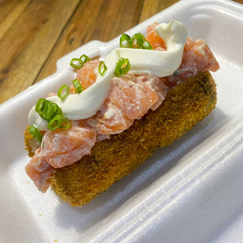 Alga, arroz japonês empanado na farinha panko e frito. Recheio: salmão em cubos, cream cheese e cebolinha --- Acompanha: 2 sachês de shoyu e 2 sachês de tarê.