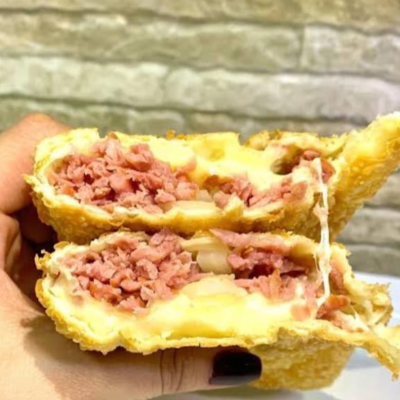 Linguiça, molho branco, queijo mussarela, alho torrado, tomate, cebola e orégano.