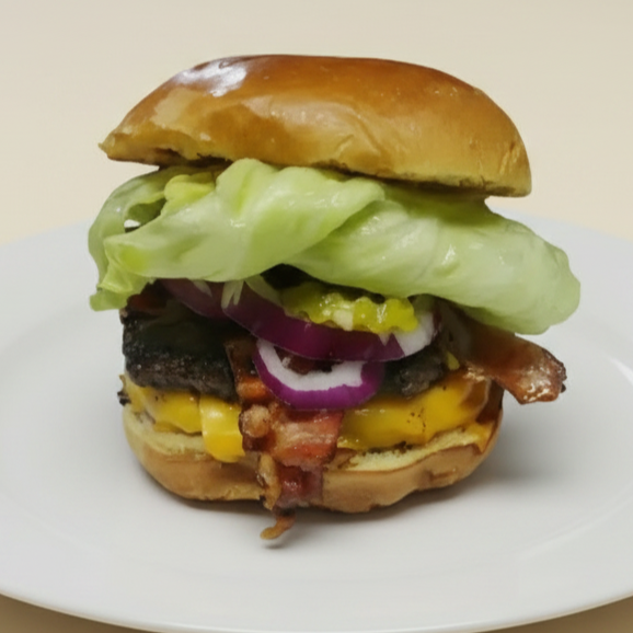 PÃO BRIOCHE, 2 HAMBÚRGUER 120 GRAMAS, BACON TRIPLO CHEDDAR, ALFACE, TOMATE, CEBOLA ROXA PICLES, MOLHO DA CASA.*Imagem meramente ilustrativa*