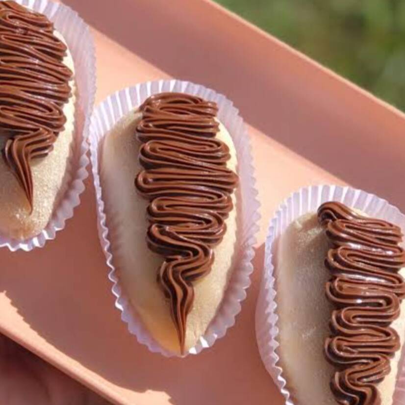 Morango envolvido em um brigadeiro de Ninho com uma camada de Nutella por cima