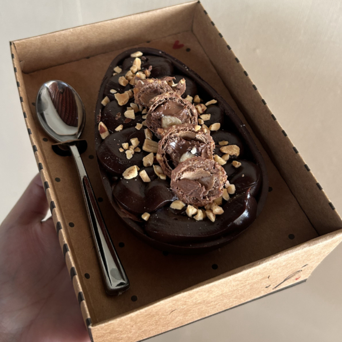 ovo recheado com ganache de chocolate 50% cacau, camada de amendoim e Nutella e bombons Ferrero Rocher