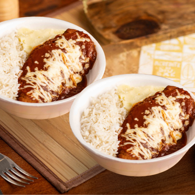 "Leve 2 no precinho!
Bife de Carne empanada, com molho de tomate e coberto com uma generosa camada de muçarela derretida.Acompanha arroz branco soltinho e purê de batatas. Aprox 400g cada."