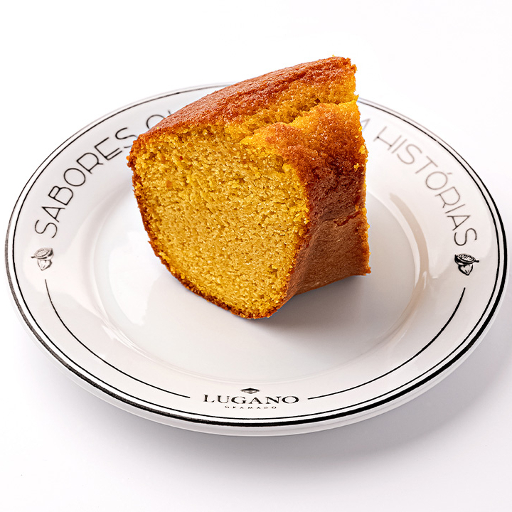 Fatia de bolo de laranja acompanhado de uma deliciosa calda de chocolate ao leite derretido.