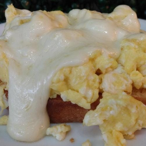 uma Fatia de pão, ovos mexidos e Queijo mussarela