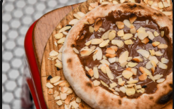 Mini pizza de 15 cm, de Nutella com amêndoas torradas.