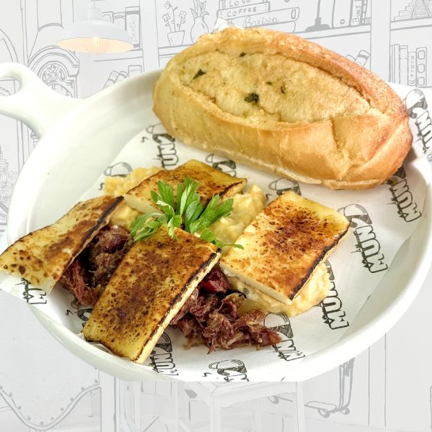 Pão Brasileiro temperado, nossos ovos mexidos super cremosos, carne seca desfiada com cebola, queijo coalho maçaricado, finalizado.